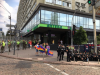 KyivPride Equality March participants hold a rainbow flag near a group of police officers. As part of its LGBTI inclusion work, NDI organizes cooperation meetings between LGBTI organizations and law enforcement officials.