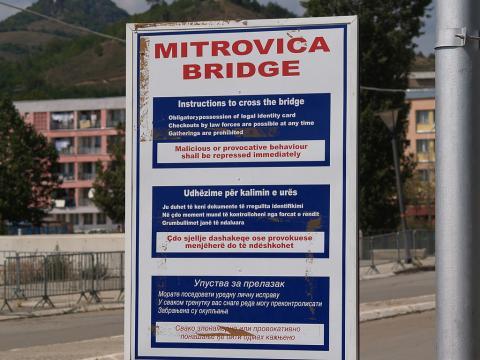  A sign at the entrance to the Mitrovica bridge, which crosses the Ibar River dividing the ethnic Serb and ethnic Albanian communities, warns travelers that “malicious or provocative behaviour shall be repressed immediately.” Credit: Dave Proffer