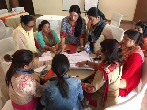 During a training for women candidates for local elections, a group of them are working on developing an effective canvassing script to use when they go door-to-door. 